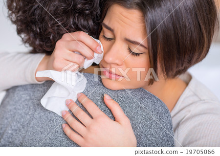 Crying woman is hugging her sister. Crying woman is hugging her sister. 19705066