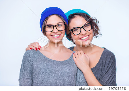 Happy-looking sisters are hugging together. 19705258