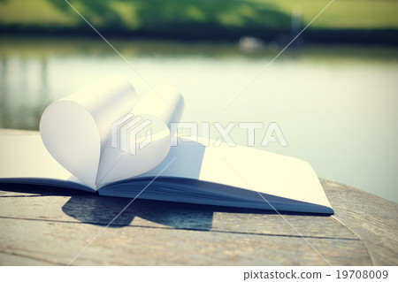 close up heart shape from paper book 19708009