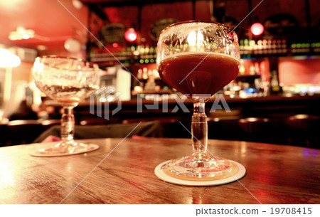 Dark beer in glass on the background of the bar Dark beer in glass on the background of the bar 19708415