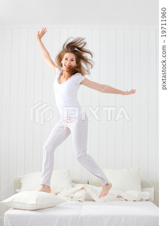 happy girl jumping and having fun in bed 19711960