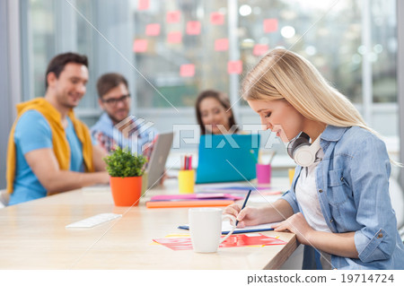 Attractive young designers are discussing new 19714724
