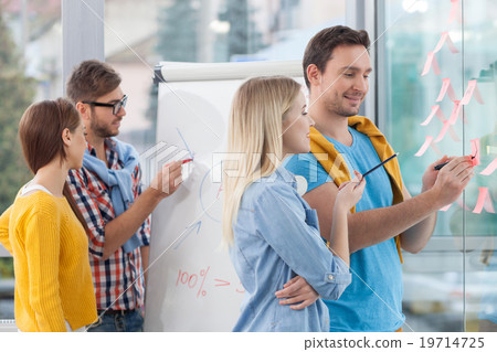Skillful four colleagues are working in office 19714725