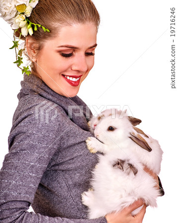 Portrait of a young woman with little bunny. 19716246
