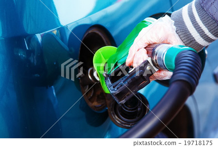 man pumping gasoline fuel in car at gas station man pumping gasoline fuel in car at gas station 19718175