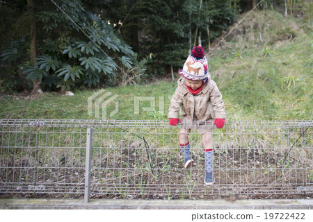 A girl overcoming a fence 19722422