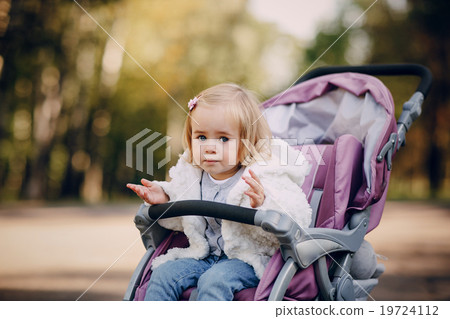 young family walking in the park 19724112