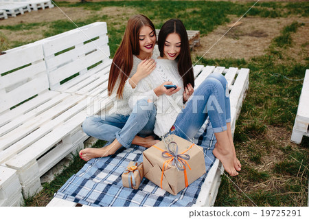 Two girls make selfie with gifts 19725291