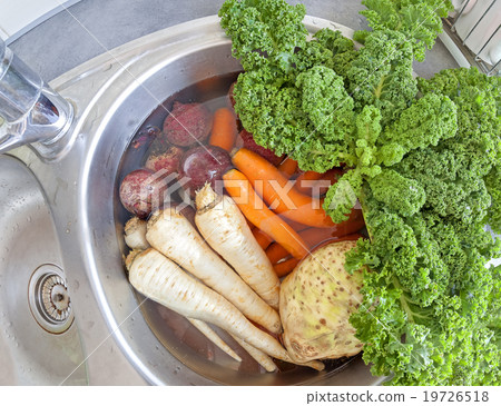 Dirty vegetables in a kitchen sink. 19726518