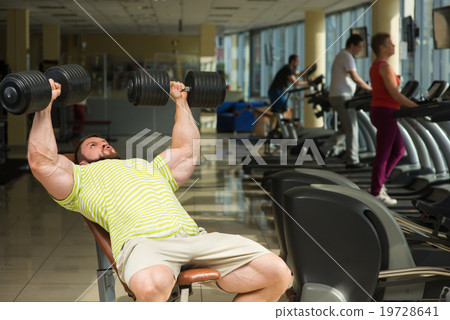 Champion with dumbbells. 19728641