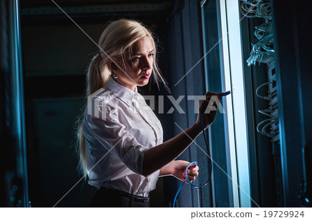 Young engineer businesswoman in server room Young engineer businesswoman in server room 19729924