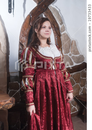 Attractive young woman in red dress in retro style Attractive young woman in red dress in retro style 19733433