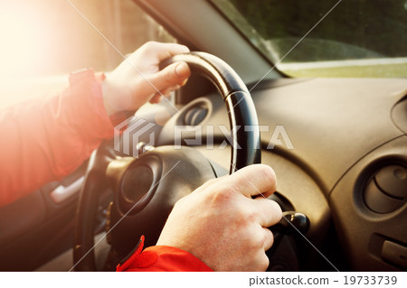 Man hands holding steering wheel 19733739