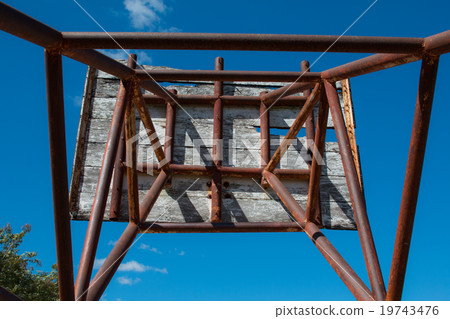 Basketball hoop is broken and wood board damaged 19743476