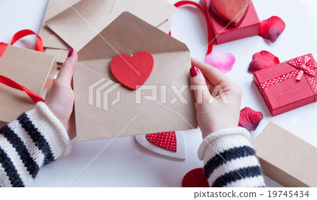 Woman preparing envelope and gift Woman preparing envelope and gift 19745434