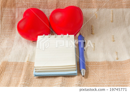 Double red heart with blank notebook on fabric Double red heart with blank notebook on fabric 19745771