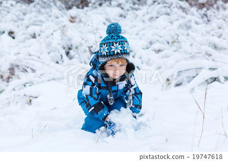 Happy child having fun with snow in winter Happy child having fun with snow in winter 19747618