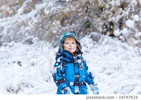Happy child having fun with snow in winter Happy child having fun with snow in winter 19747619