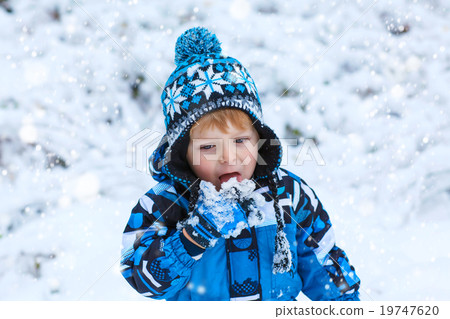 Happy child having fun with snow in winter Happy child having fun with snow in winter 19747620