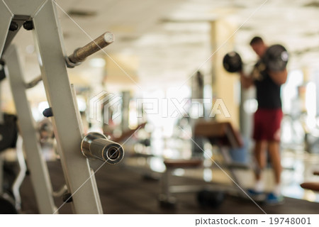 Sportsman with barbell. 19748001