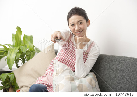 Housewife watching TV Housewife watching TV 19748613