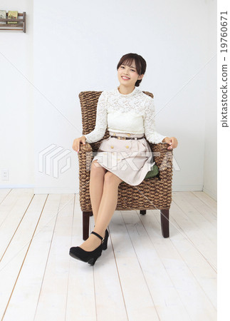 A young woman sitting on a chair 19760671