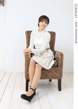 A young woman sitting on a chair 19760672