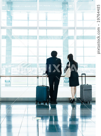 Business: Male and female colleagues in overseas business trip air suit 19764485
