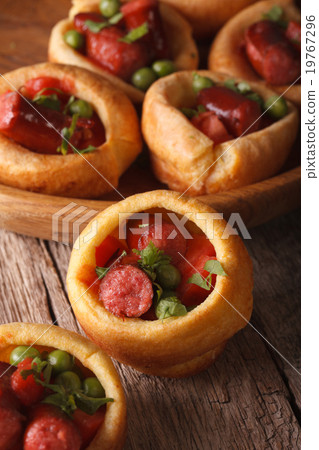 Yorkshire puddings stuffed with sausages close-up 19767296