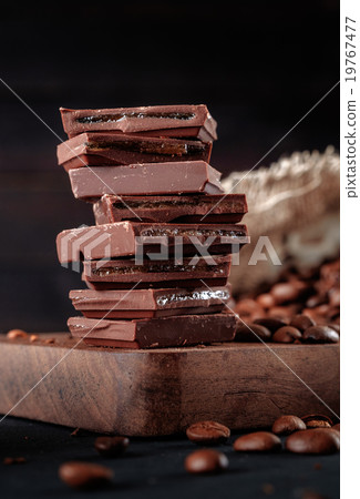 coffee beans and stack of brown chocolate. coffee beans and stack of brown chocolate. 19767477