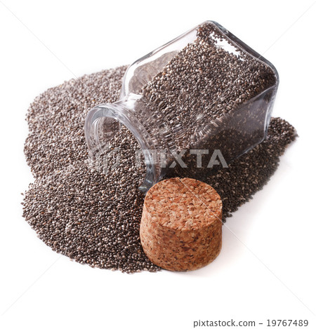 Carefully selected Chia seeds spill out of a jar 19767489