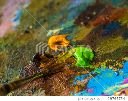 Paintbrush on the palette for mixing oil paints Paintbrush on the palette for mixing oil paints 19767754