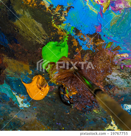 Paintbrush on the palette for mixing oil paints. Paintbrush on the palette for mixing oil paints. 19767755