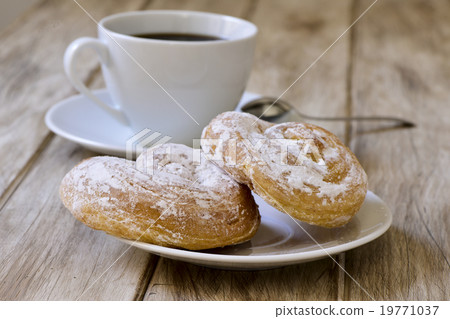 coffee and spanish esnaimadas on a rustic table 19771037