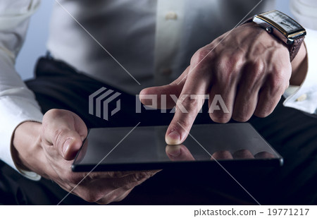 Man working on digital tablet Man working on digital tablet 19771217
