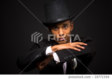 Handsome man in top hat posing with cane 19771584