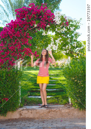 young woman in the park, the arch of flowers 19773397