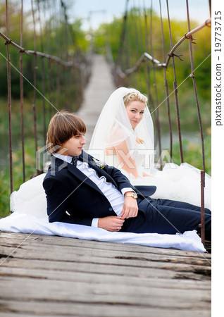 bride groom sitting on the bridge bride groom sitting on the bridge 19773715
