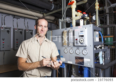 Stock Photo: Technician inspecting heating system in boiler