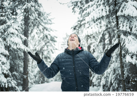 Happy man in winter season with tree on the back Happy man in winter season with tree on the back 19776659