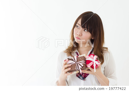 Girls high school student thinking who they are sending gifts Preparation Student Event Image Present Front Girls high school student thinking who they are sending gifts Preparation Student Event Image Present Front 19777422