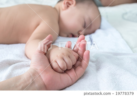 Asian baby hand on the adult hand 19778379