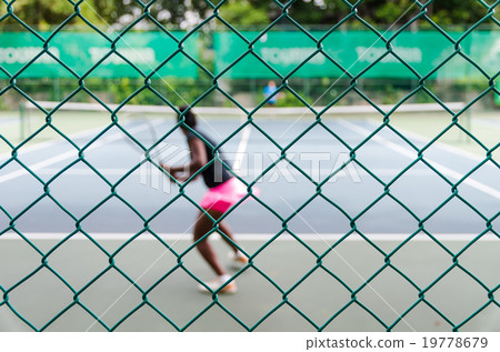 Defocus and blur photo of tennis court with tennis player for sp Defocus and blur photo of tennis court with tennis player for sp 19778679
