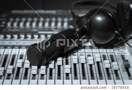 Close up of microphone with headphone on mixer, music instrument Close up of microphone with headphone on mixer, music instrument 19778938
