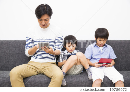 Dad and 2 sons who play the game 19786972