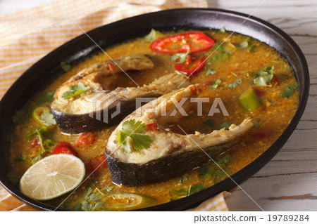 Spicy fish curry with vegetables close-up on plate Spicy fish curry with vegetables close-up on plate 19789284