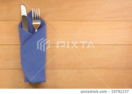 knife and fork at napkin on wood knife and fork at napkin on wood 19792237