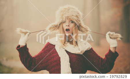 Surprised pretty fashion woman in fur winter hat 19792829