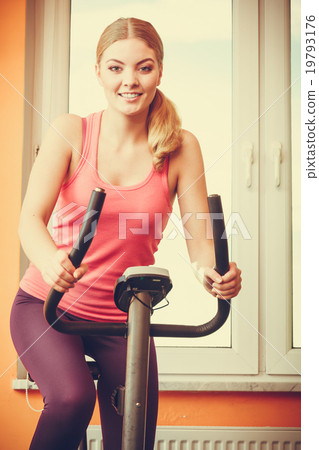 Woman working out on exercise bike. Fitness. Woman working out on exercise bike. Fitness. 19793176