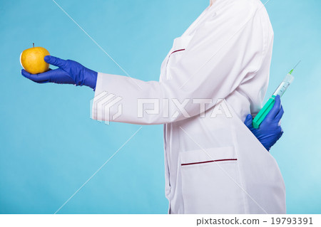 Injection into red apple, genetic modification concept 19793391